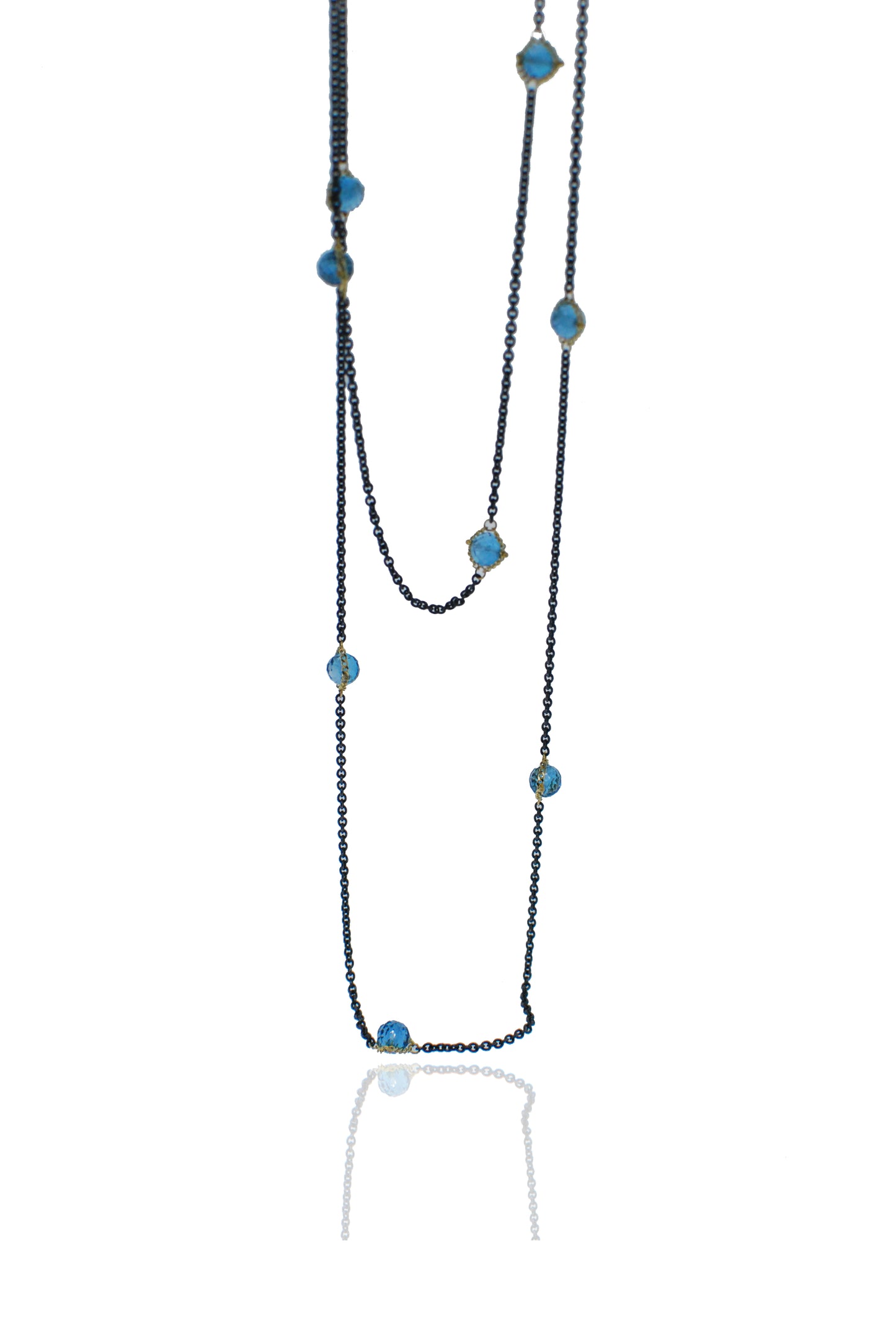 Blue topaz station necklace featuring oxidized sterling silver and 18k yellow gold chain links.