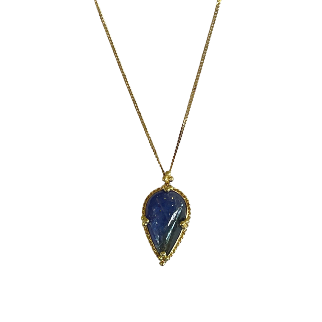 Pear-shaped cabochon tanzanite pendant in 18k yellow gold on a delicate chain.