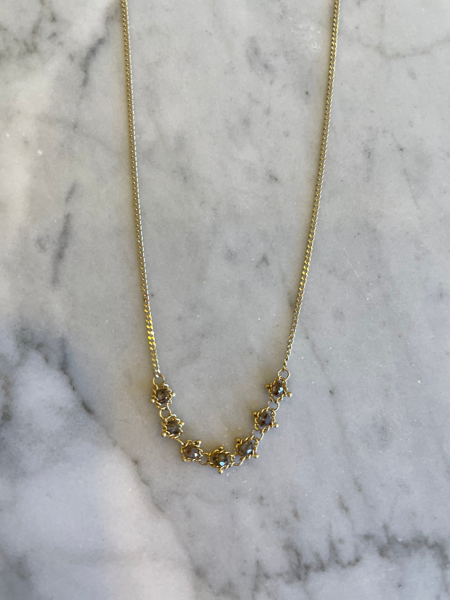 18k yellow gold necklace featuring a delicate textile chain and a row of sparkling champagne diamonds.