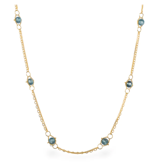 18k yellow gold chain necklace featuring hand-woven London Blue Topaz stones and delicate golden hoops.