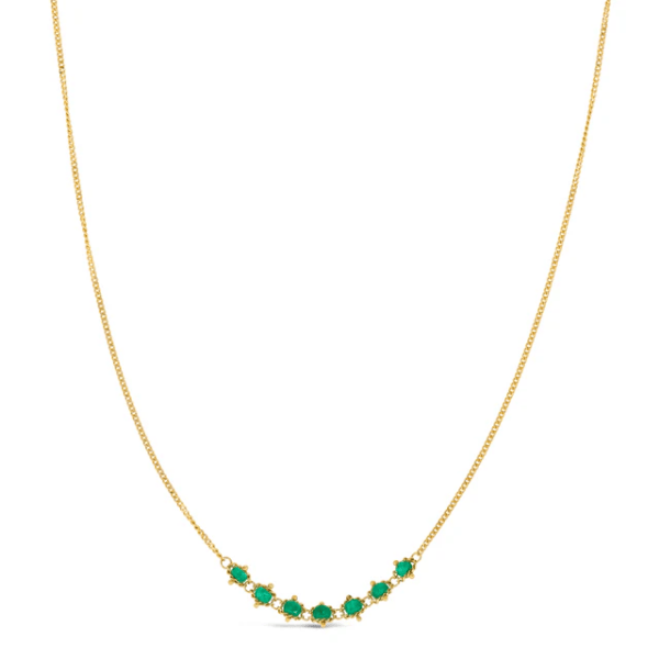 18k yellow gold chain necklace featuring a delicate row of seven vibrant green emeralds.