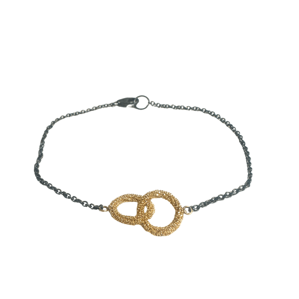 7-inch bracelet featuring interlocking 18K yellow gold Stardust circles on an oxidized silver chain.