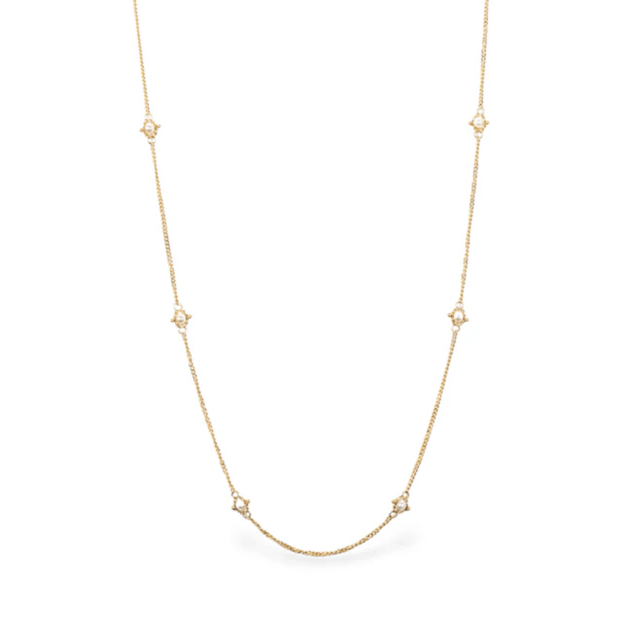 18k yellow gold station necklace featuring delicate freshwater pearls spaced evenly along a shimmering, textured chain.