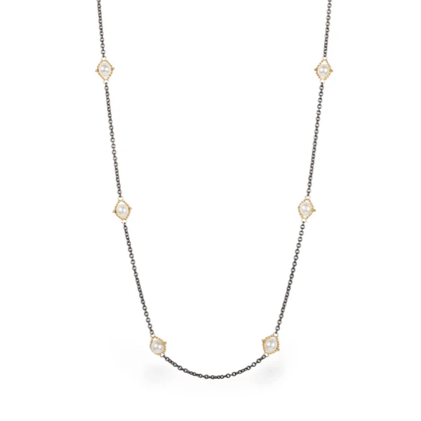 Freshwater pearls set in 18k yellow gold on an oxidized sterling silver station chain.
