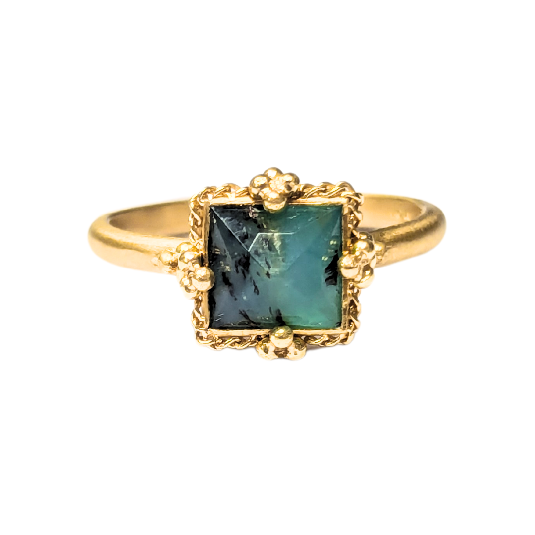 18k yellow gold ring featuring a square faceted Peruvian opal in a decorative beaded setting.