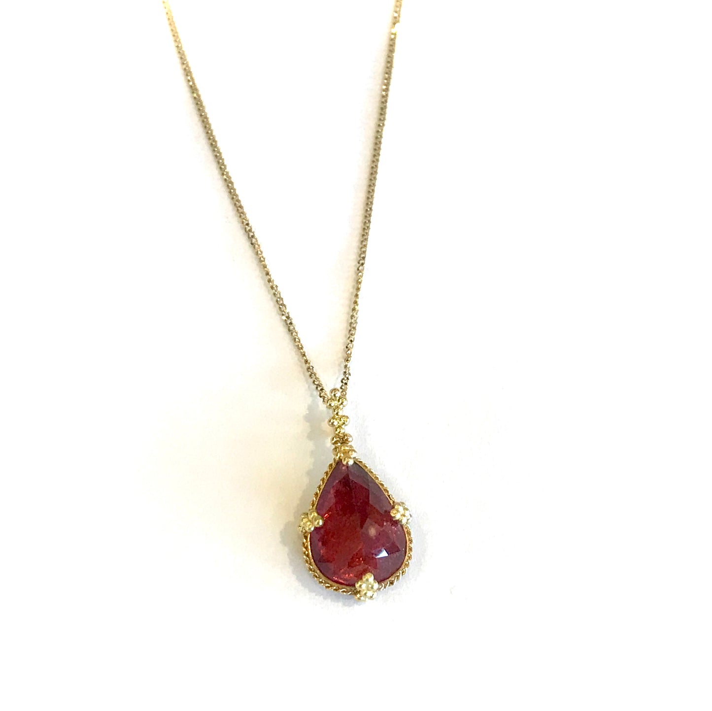 Pear-shaped pink tourmaline pendant on an 18k yellow gold chain.