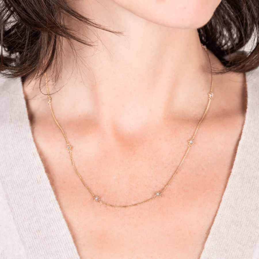 18k yellow gold station chain necklace featuring handwoven silver diamonds on a delicate textile-inspired link chain.