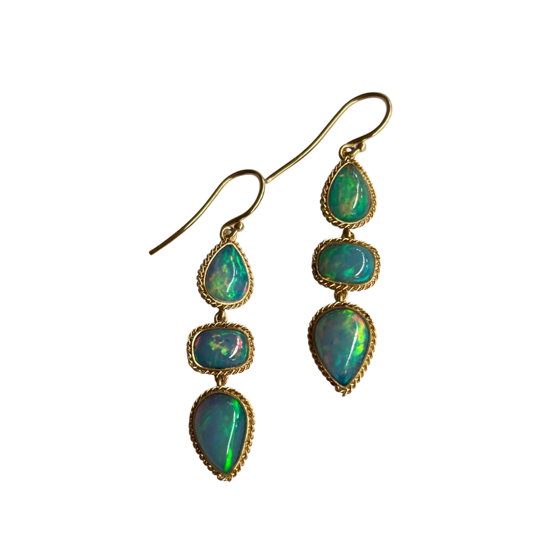 18k yellow gold triple drop earrings featuring six iridescent opals with a rope-textured bezel setting.