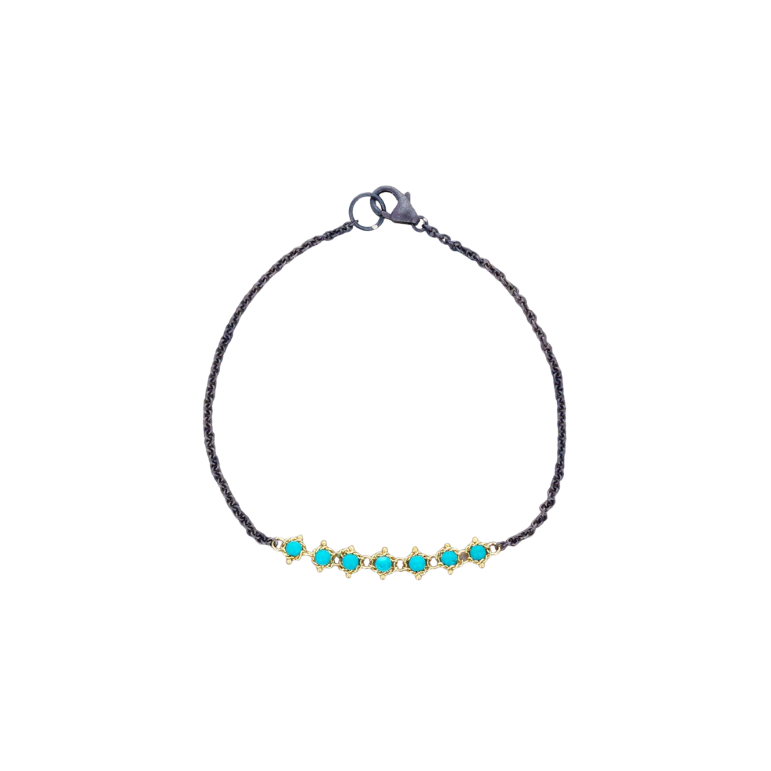 Amali 7-inch bracelet featuring turquoise stones set in 18k yellow gold on an oxidized sterling silver chain.