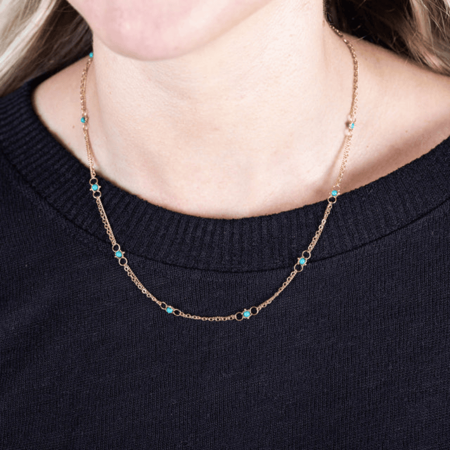18k yellow gold chain necklace featuring delicate blue turquoise stones set between small gold hoops.