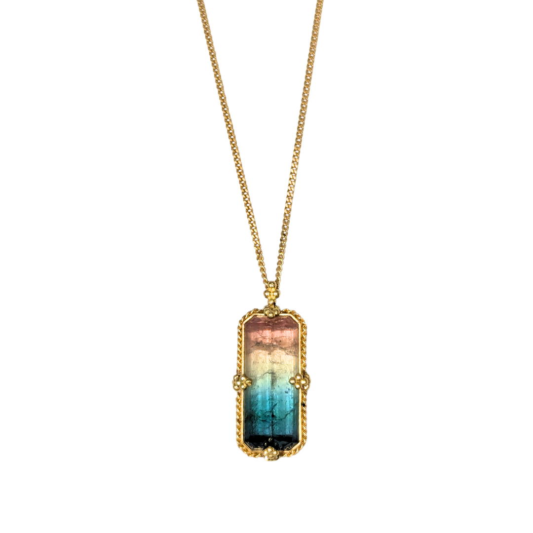 Emerald cut watermelon tourmaline pendant in 18k yellow gold on a delicate gold chain.