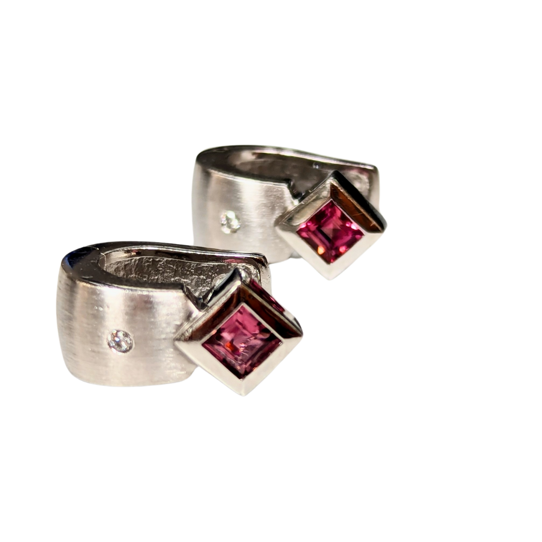 14k satin white gold huggie earrings featuring square-cut pink tourmaline accents and hinged closures.