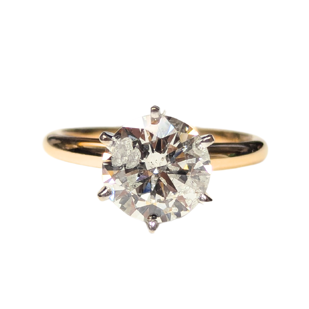 14k two-tone gold solitaire ring featuring a 2.05 carat round brilliant cut diamond in a six-prong setting.