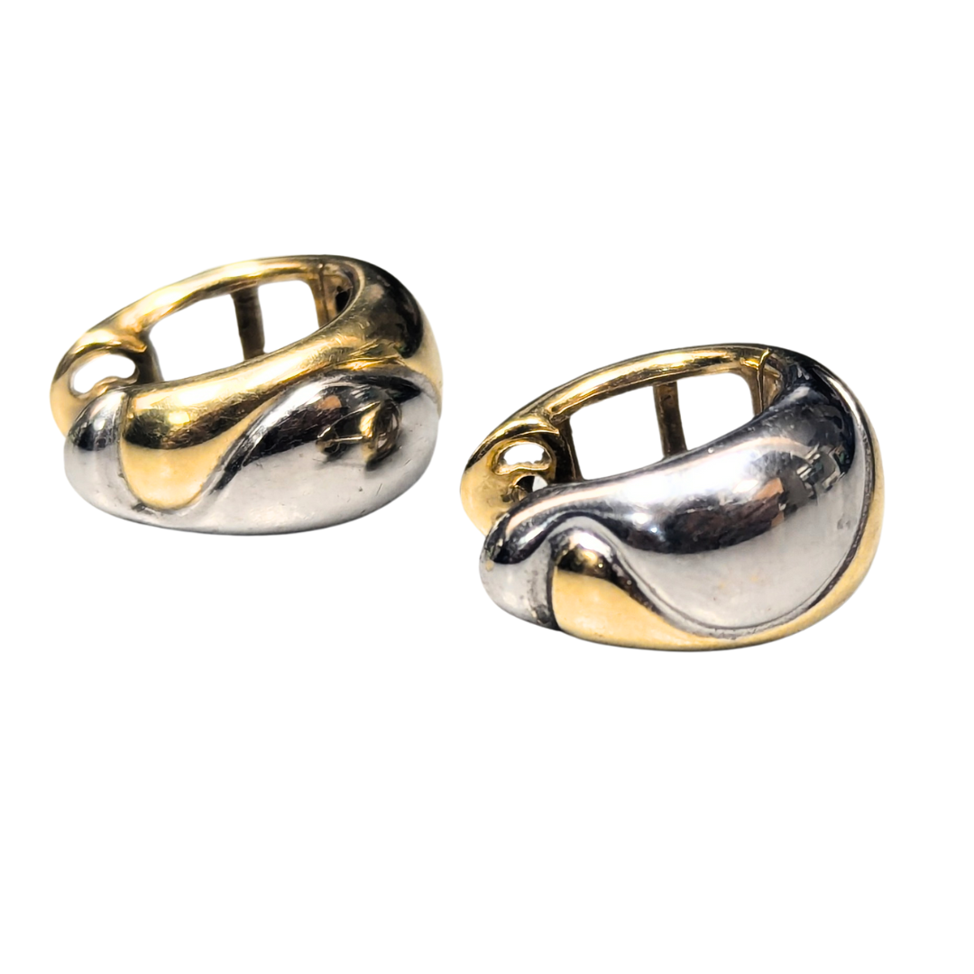 Modernist huggie earrings in 14k yellow and white gold with a polished, two-tone hinged design.