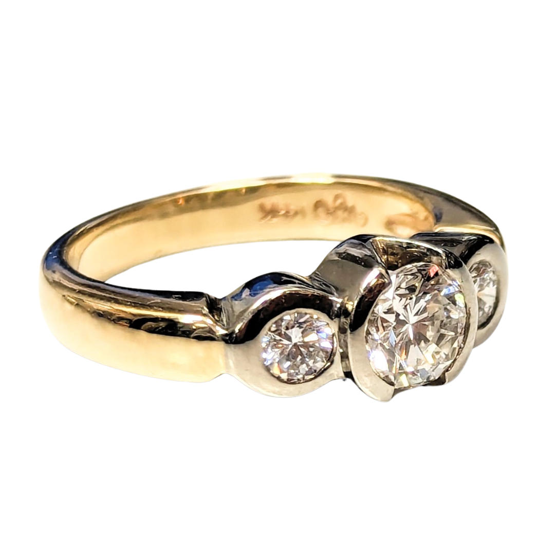 14k two-tone gold three-stone engagement ring featuring a 0.56ct center diamond and two side diamonds.