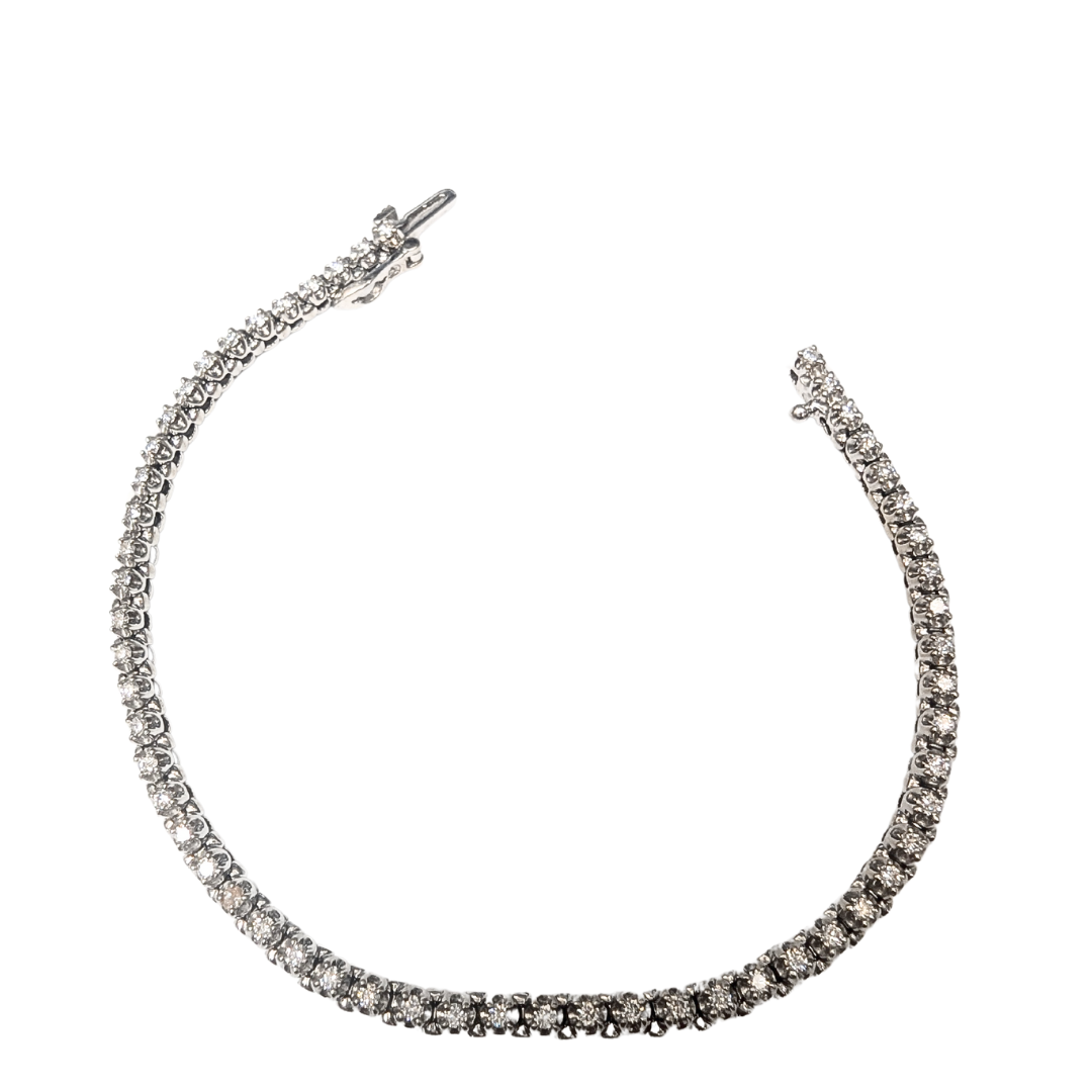 14k white gold tennis bracelet featuring 1.00 carat of round brilliant diamonds with a secure safety clasp.
