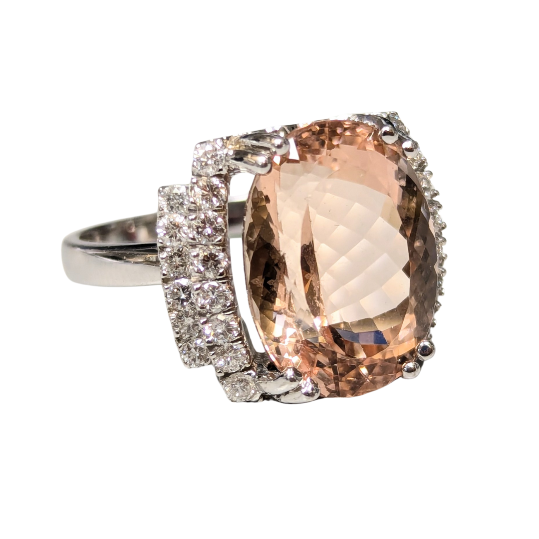 14k white gold ring featuring an 11.30ct cushion cut morganite accented by 0.50ct round brilliant diamond side stones.