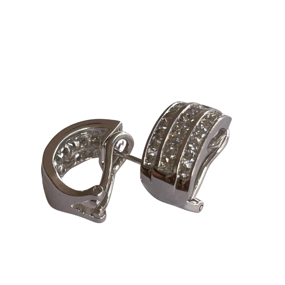 14k white gold hoop earrings featuring three rows of channel-set round and princess-cut diamonds.