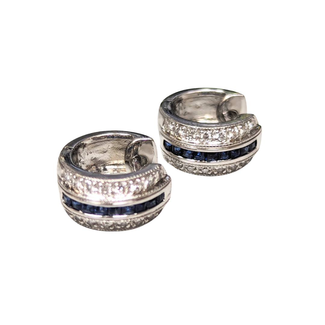 14k white gold huggie earrings featuring square blue sapphires and rows of sparkling round brilliant cut diamonds.