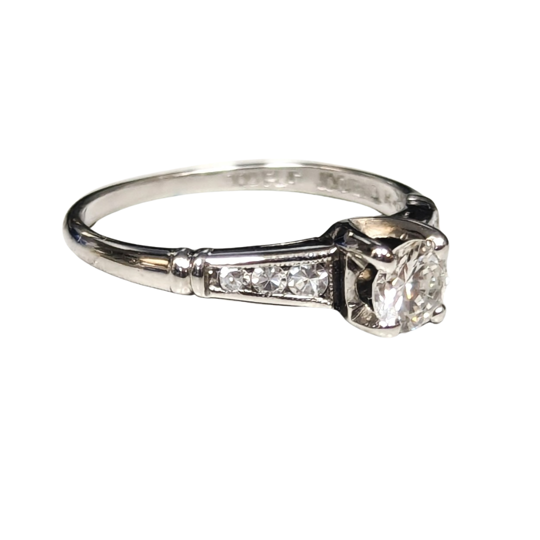 Platinum engagement ring with a 0.28ct round brilliant diamond center and six side diamonds, size 4.75.