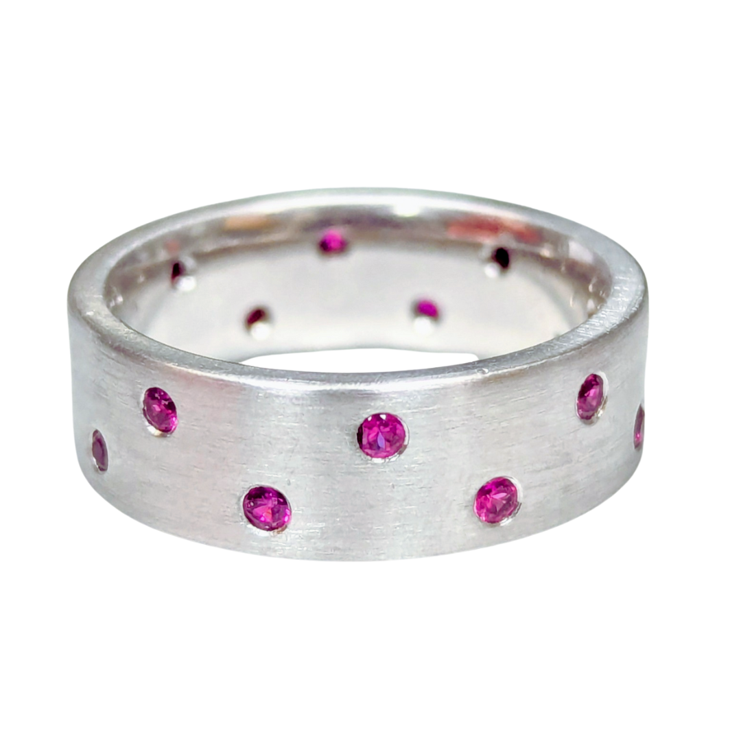 14k white gold band with a satin finish and 16 flush-set round rubies, size 5.5.