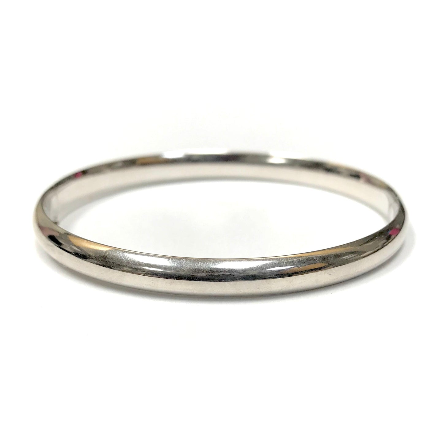 14k white gold hinged bangle featuring a smooth, polished finish and a 6.2mm width.