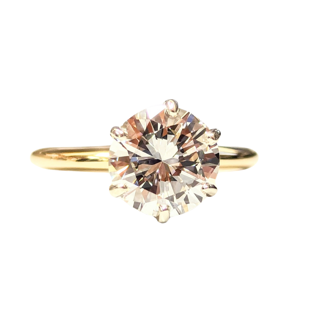 2.11 carat round brilliant diamond solitaire engagement ring set in polished 14k yellow gold.