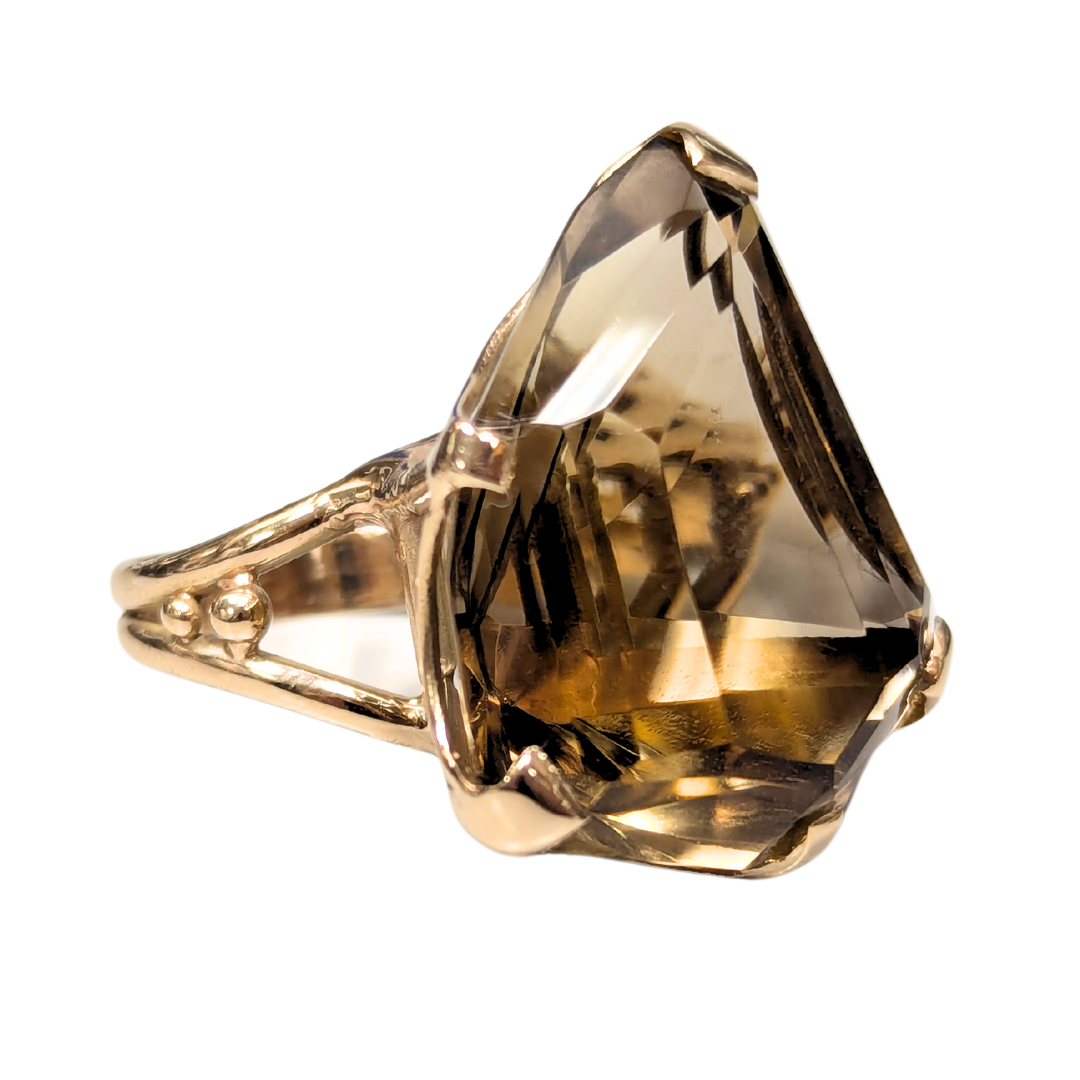 14k yellow gold ring featuring a large 35-carat freeform smoky quartz stone in a unique prong setting.