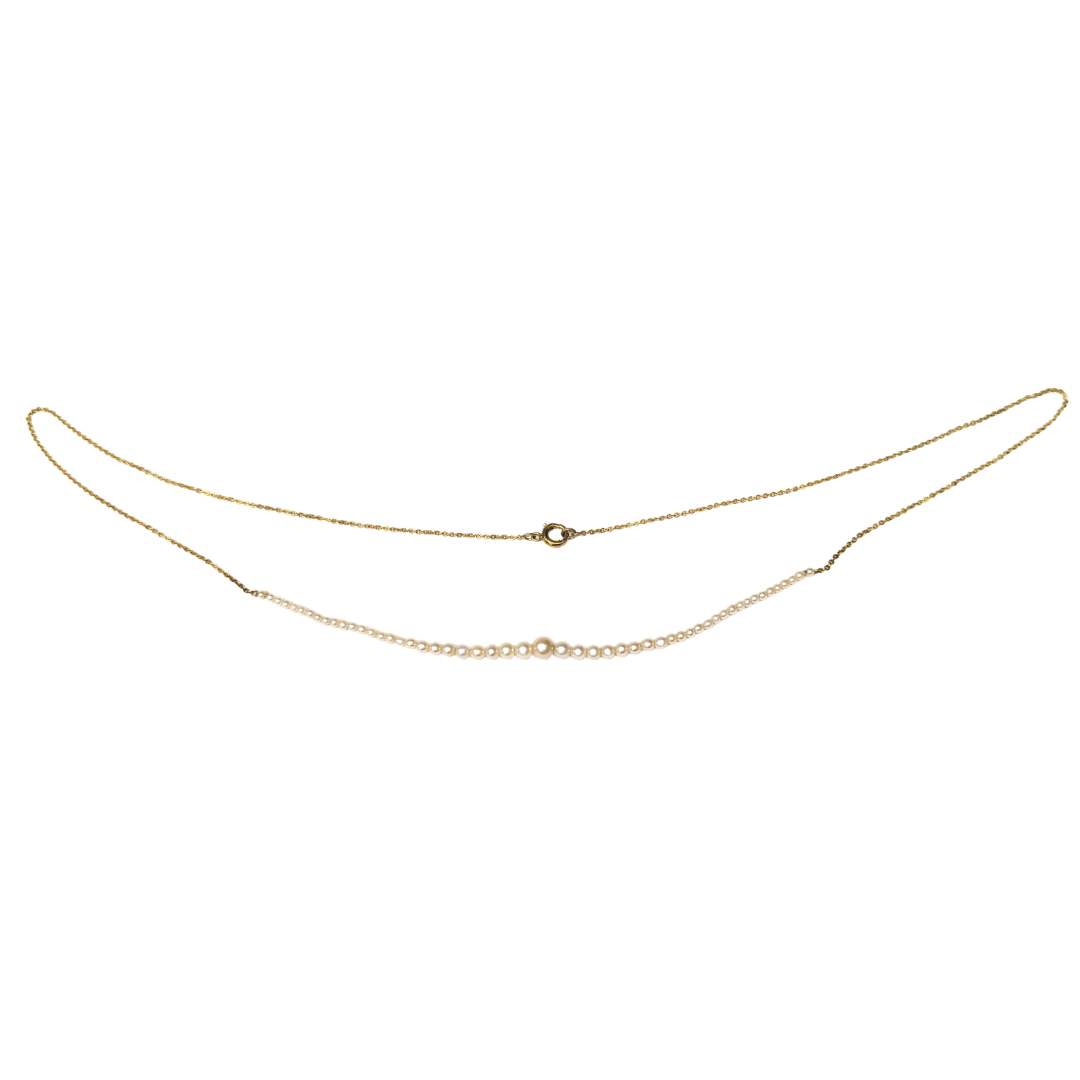 14k yellow gold add-a-pearl necklace featuring 55 natural pearls ranging from 1.8mm to 4.2mm on a delicate gold chain.