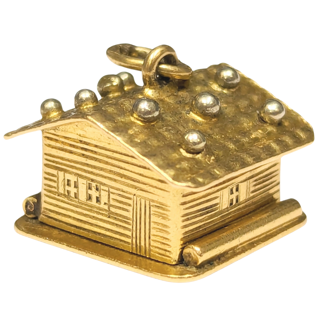 14k yellow gold articulating Swiss chalet charm with textured roof details and a hinged design.