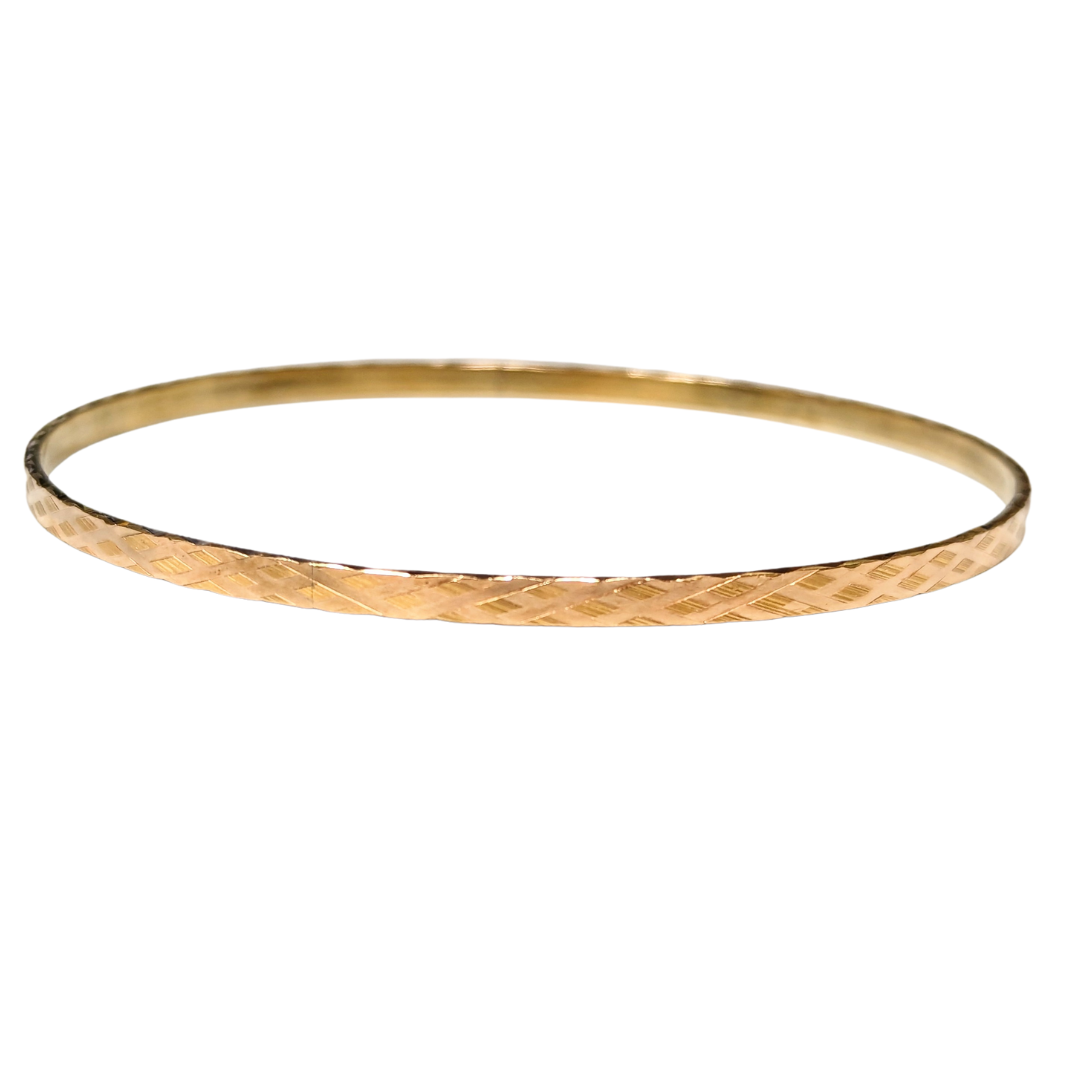 14k yellow gold bangle bracelet featuring a textured diagonal cross-hatch pattern, handcrafted in Greece.