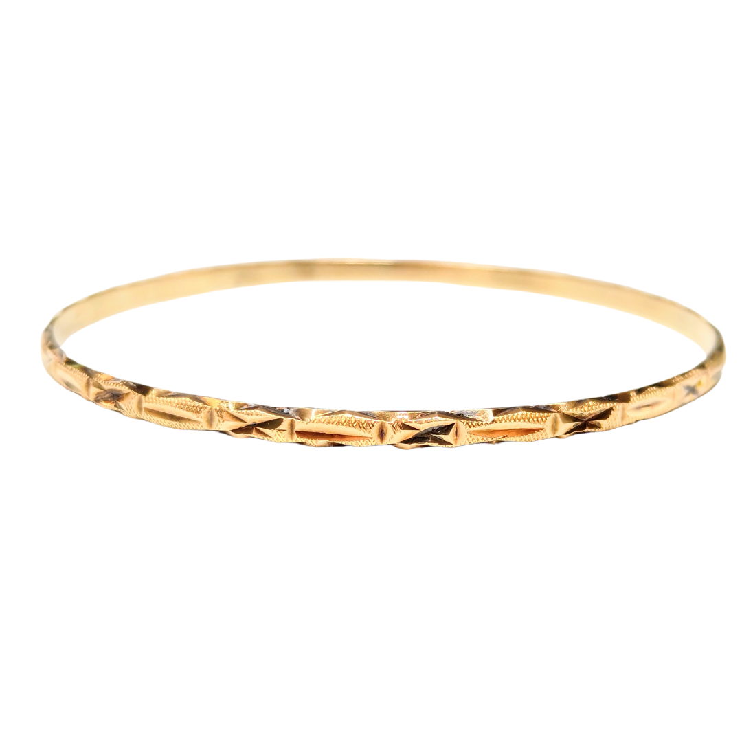 14k yellow gold bangle featuring an intricate cross-hatch X-pattern, handcrafted in Greece.