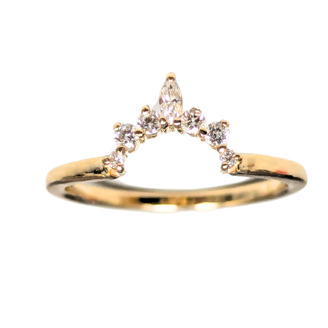 14k yellow gold contour wedding band featuring one marquise and six round brilliant cut diamonds.