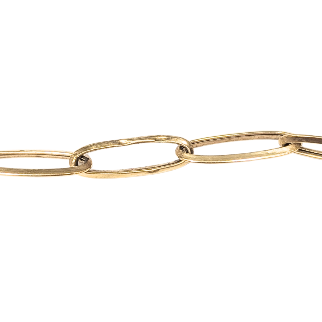 Close-up of a 14k yellow gold elongated oval link chain with a minor ding on one link.