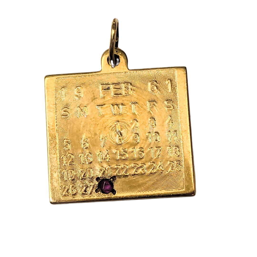 14k yellow gold square February calendar charm featuring an engraved grid and a small embedded purple gemstone.