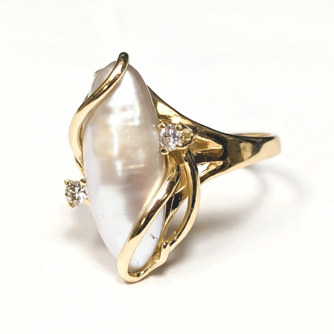 14k yellow gold freeform freshwater pearl ring featuring two brilliant cut diamond accents in a bypass setting.