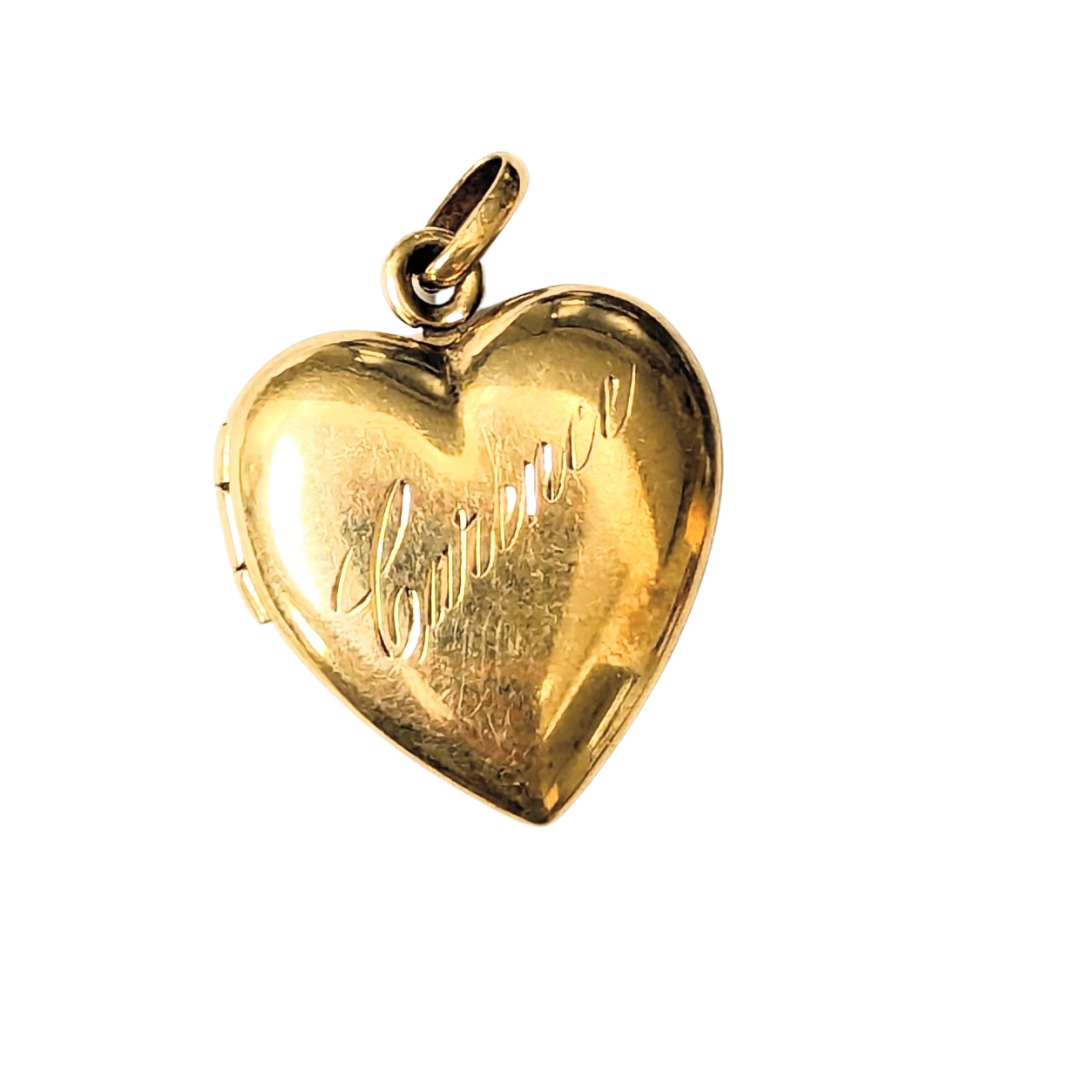Polished 14k yellow gold heart locket pendant featuring elegant cursive script engraving on a white background.