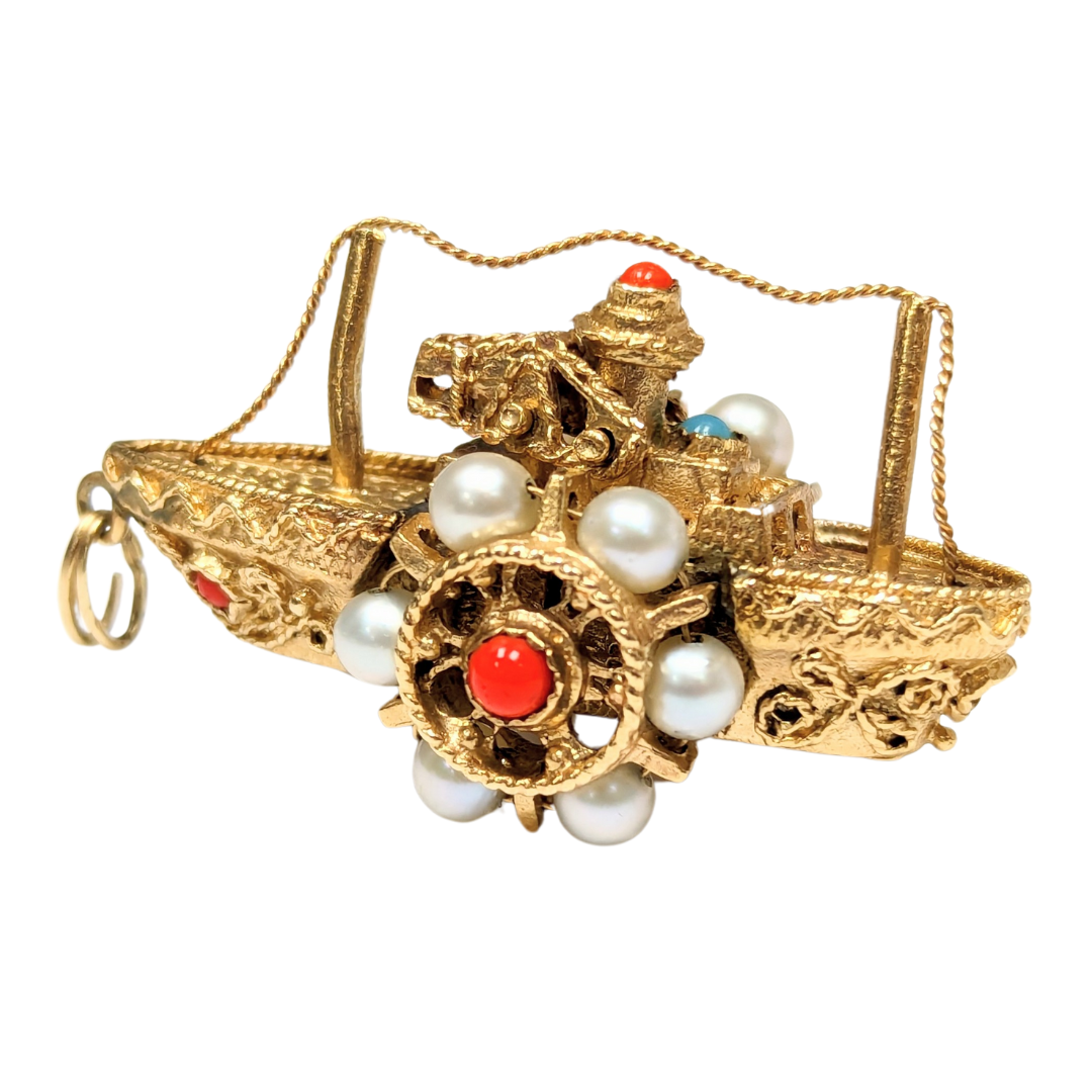 Mid-century 14k yellow gold steamboat charm with cultured pearls, coral, and turquoise accents on a movable paddle wheel.
