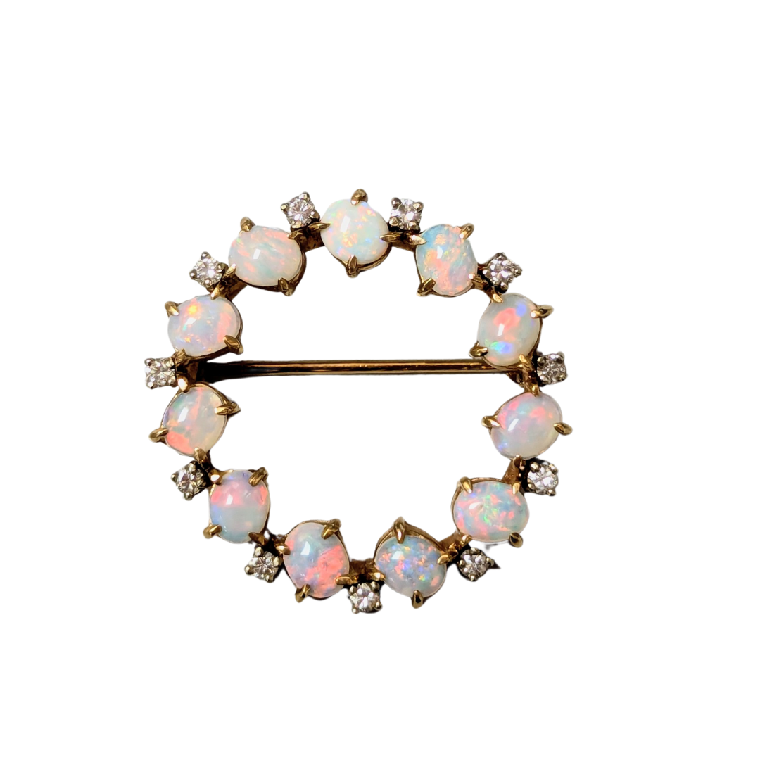 14k yellow gold circle pin featuring alternating oval opals and brilliant cut diamonds.