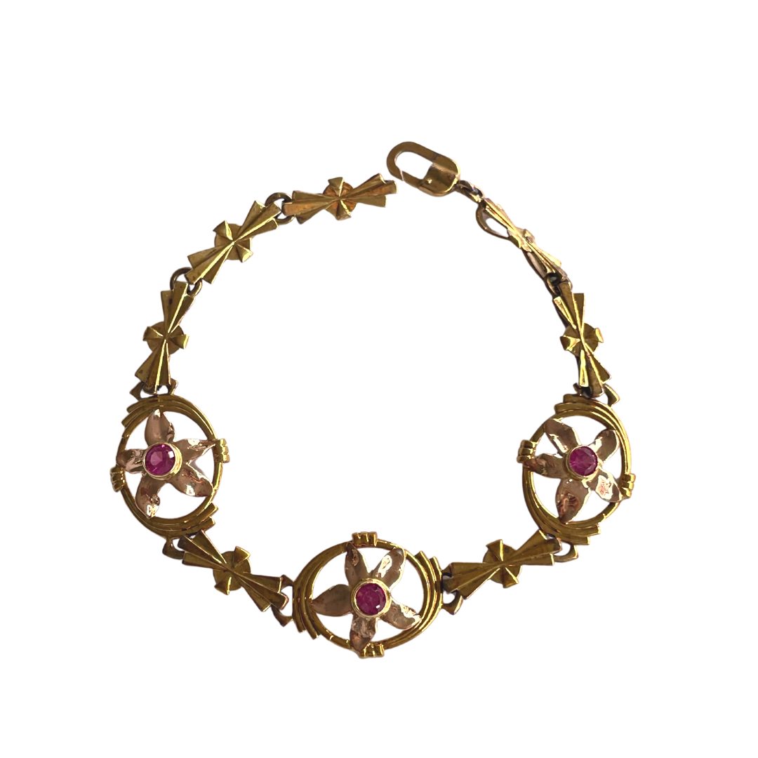 14k yellow gold bracelet featuring three floral motifs with round rubies, 6.75 inches long.