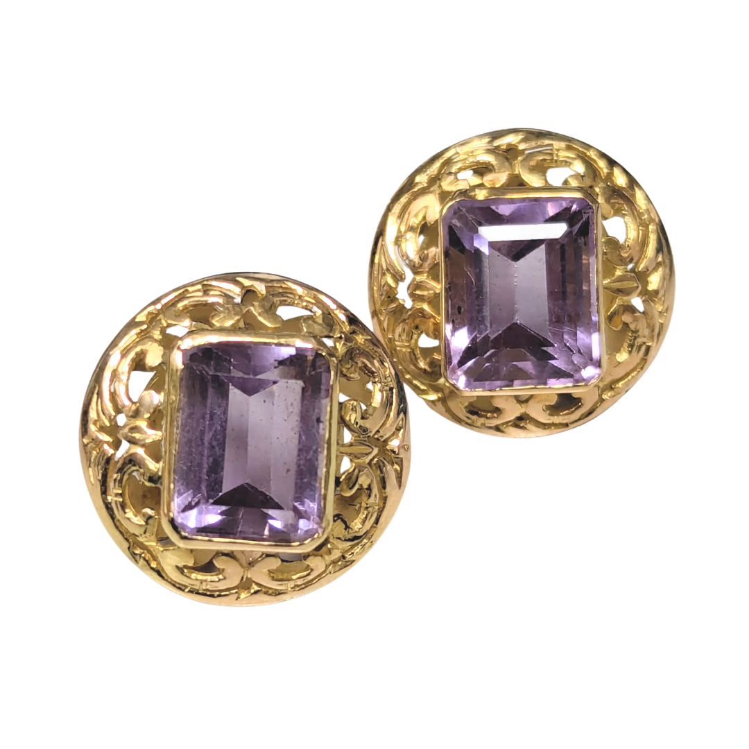 14k yellow gold earrings featuring emerald-cut amethysts set in intricate round scrollwork frames.