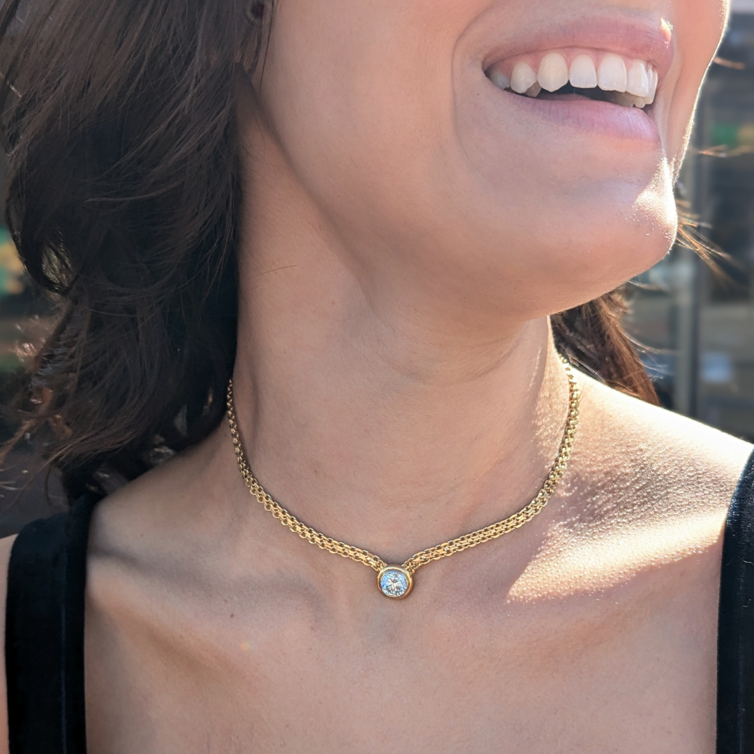 14k yellow gold woven X-link necklace featuring a 2.31ct bezel-set round brilliant diamond.