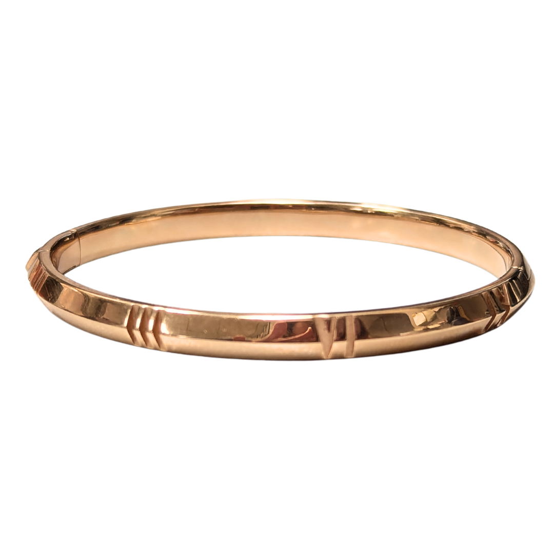 Tiffany & Co. Atlas bangle in 18k rose gold featuring engraved Roman numerals on a polished 6.5-inch circular band.