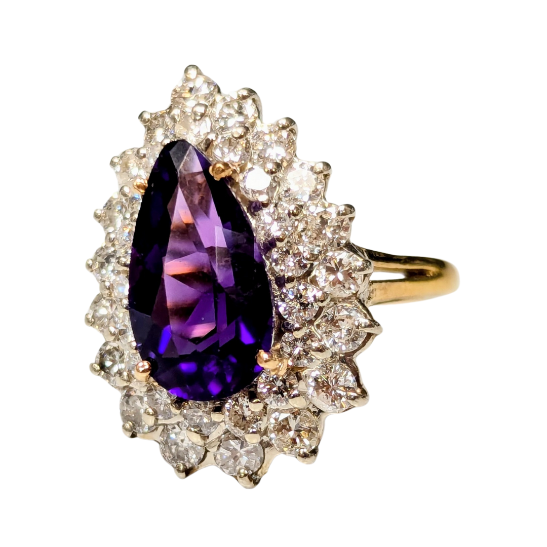 18k two-tone ring featuring a 2.90ct pear-shaped amethyst surrounded by a halo of 1.60ct round brilliant diamonds.