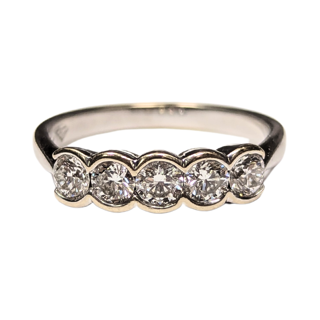 18k white gold band featuring five round brilliant diamonds in a modern half-bezel setting.