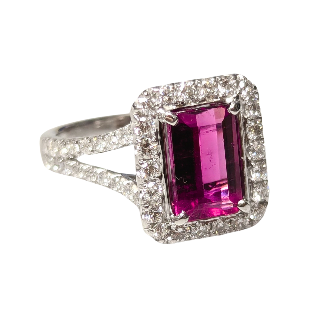 18k white gold ring featuring an emerald-cut pink tourmaline in a diamond halo split shank setting.