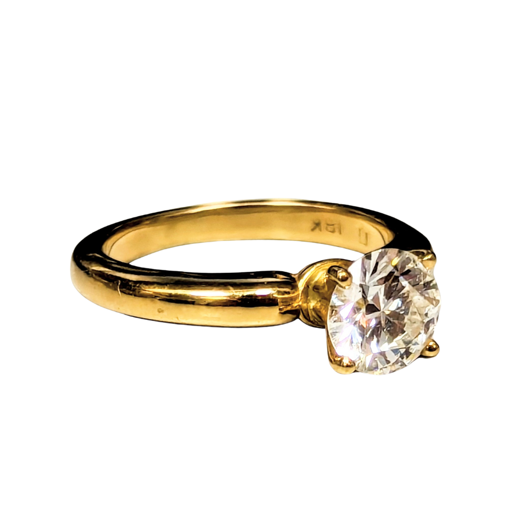 18k yellow gold solitaire engagement ring with a 1.03 carat round brilliant cut diamond on a plain polished band.