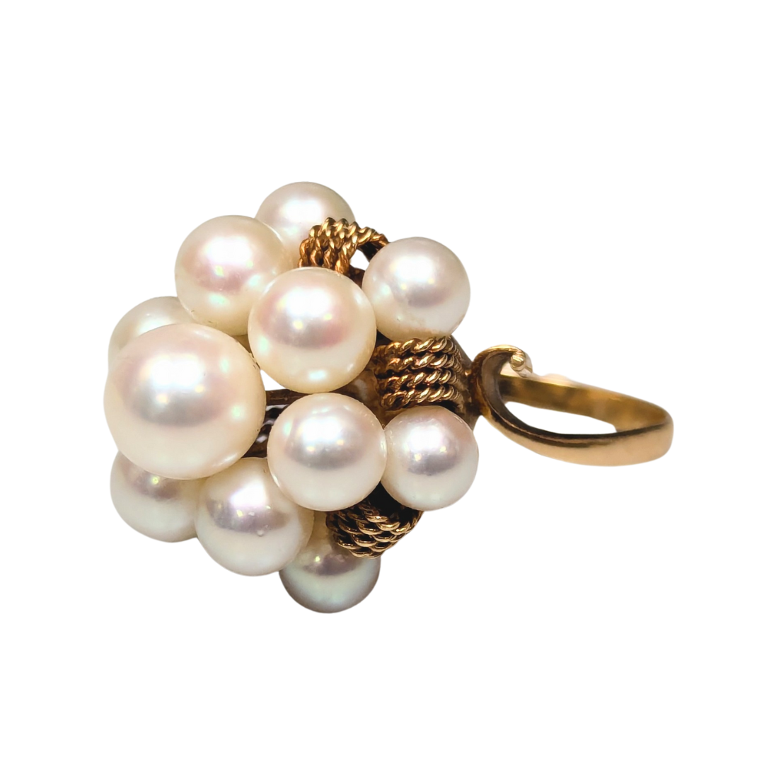 1950s 14k yellow gold cluster ring featuring thirteen cultured pearls set on a textured gold band.