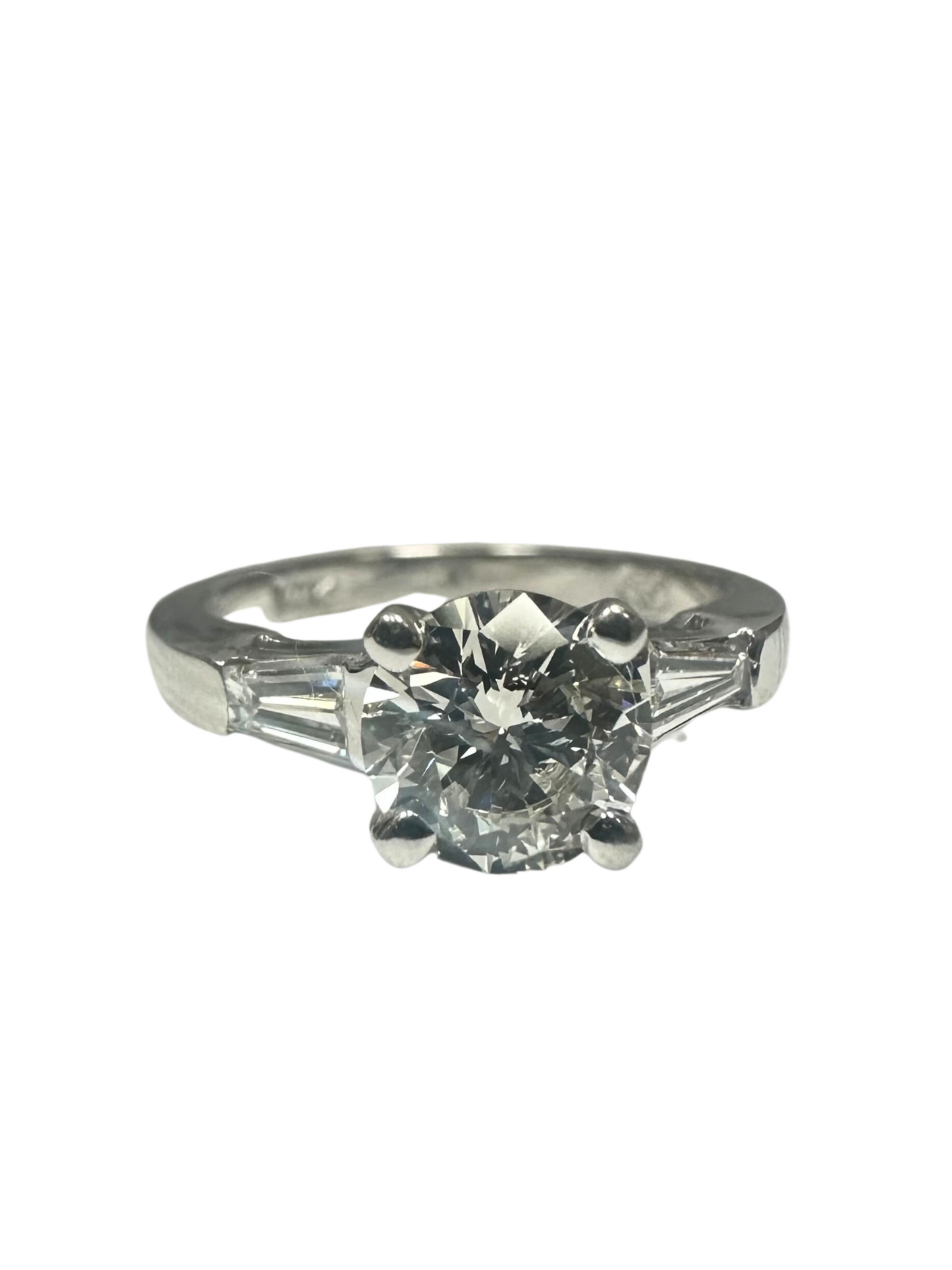 1.01 carat round diamond engagement ring in 14k white gold with tapered baguette side stones.