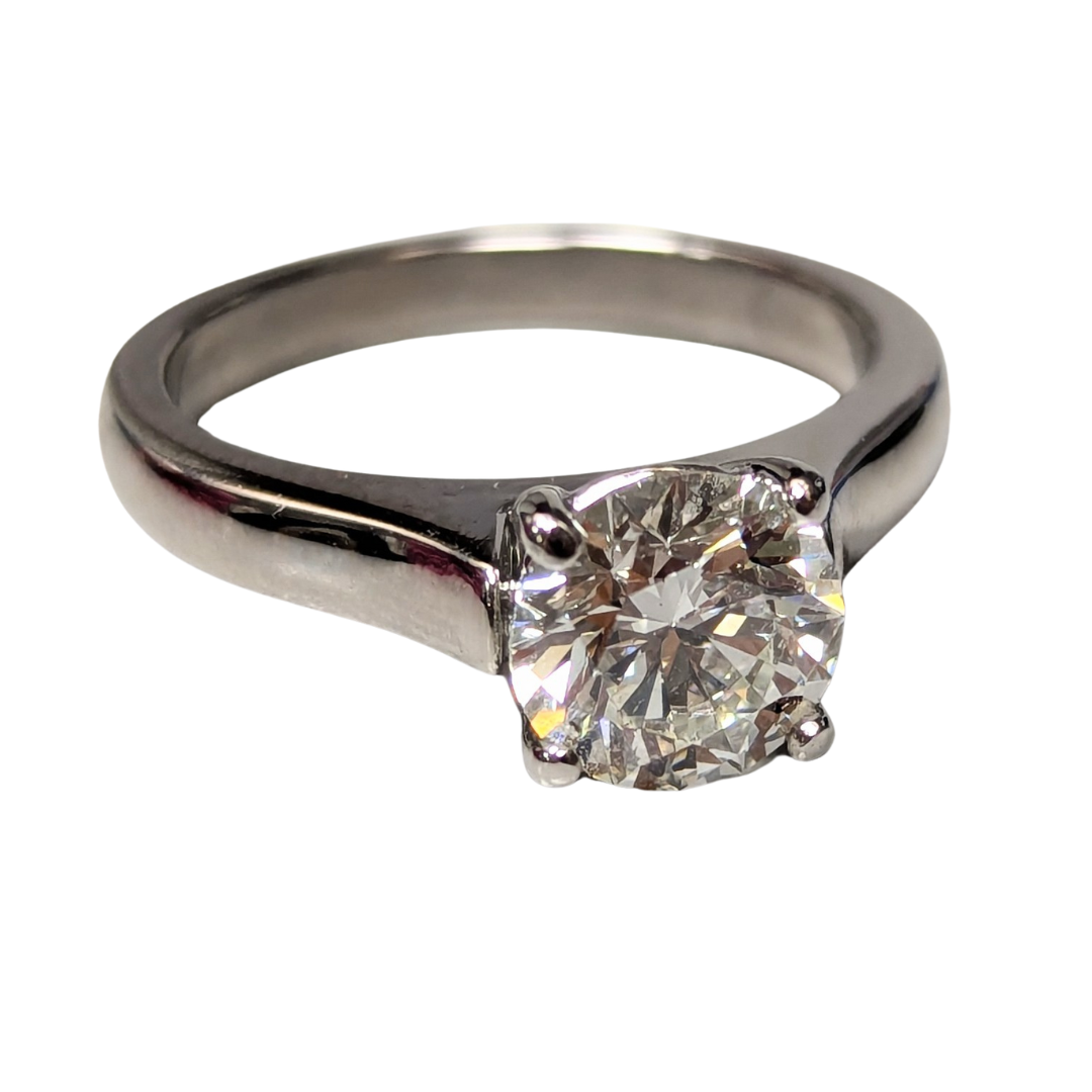 1.28 carat round brilliant diamond solitaire engagement ring set in polished platinum.